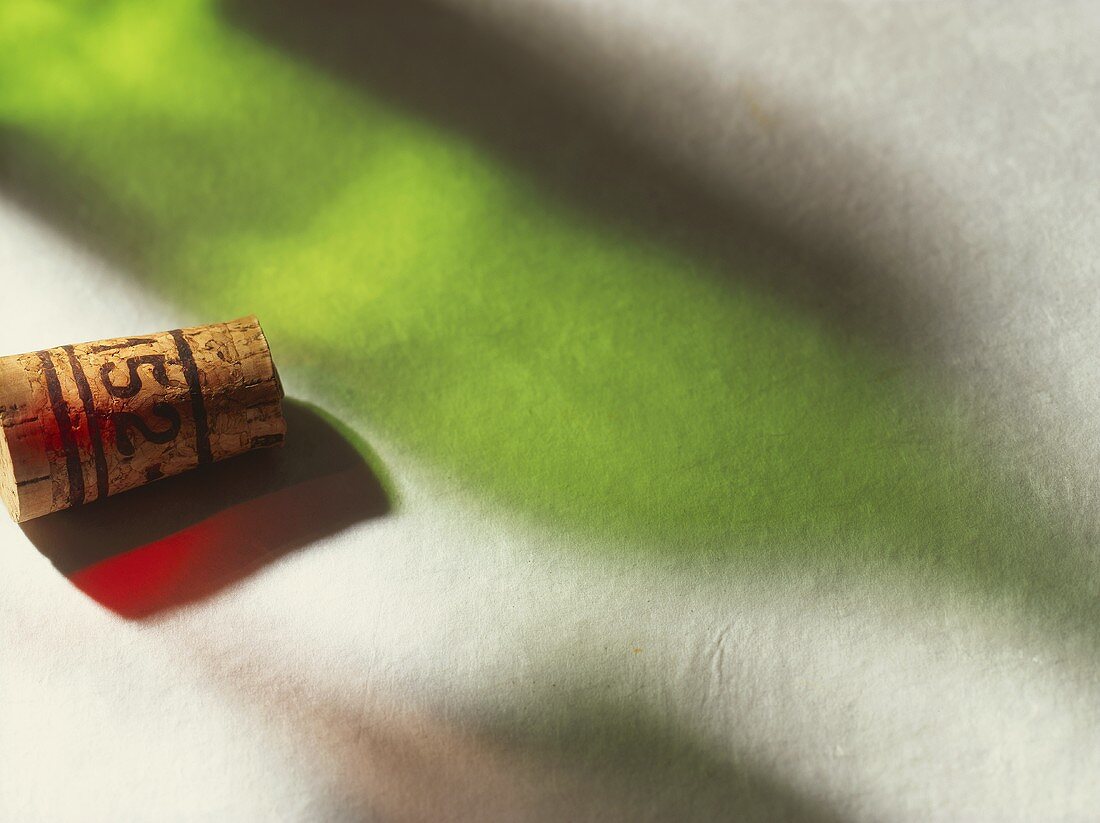 A wine cork and the shadow of a wine bottle