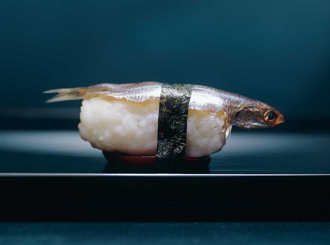 A sardine nigiri on beetroot