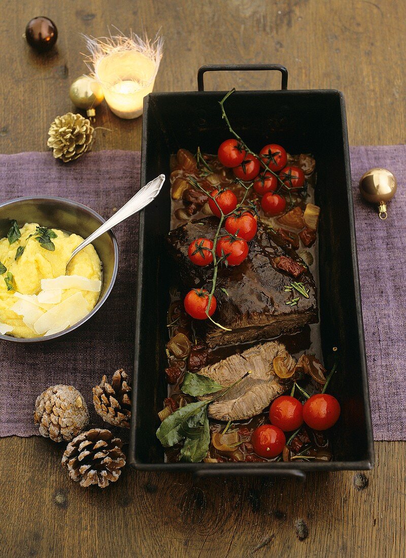 Braised beef with tomatoes in a roasting tin, polenta