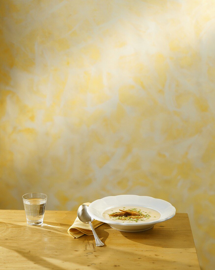 A plate of Lenten soup (bread soup) with a glass of water