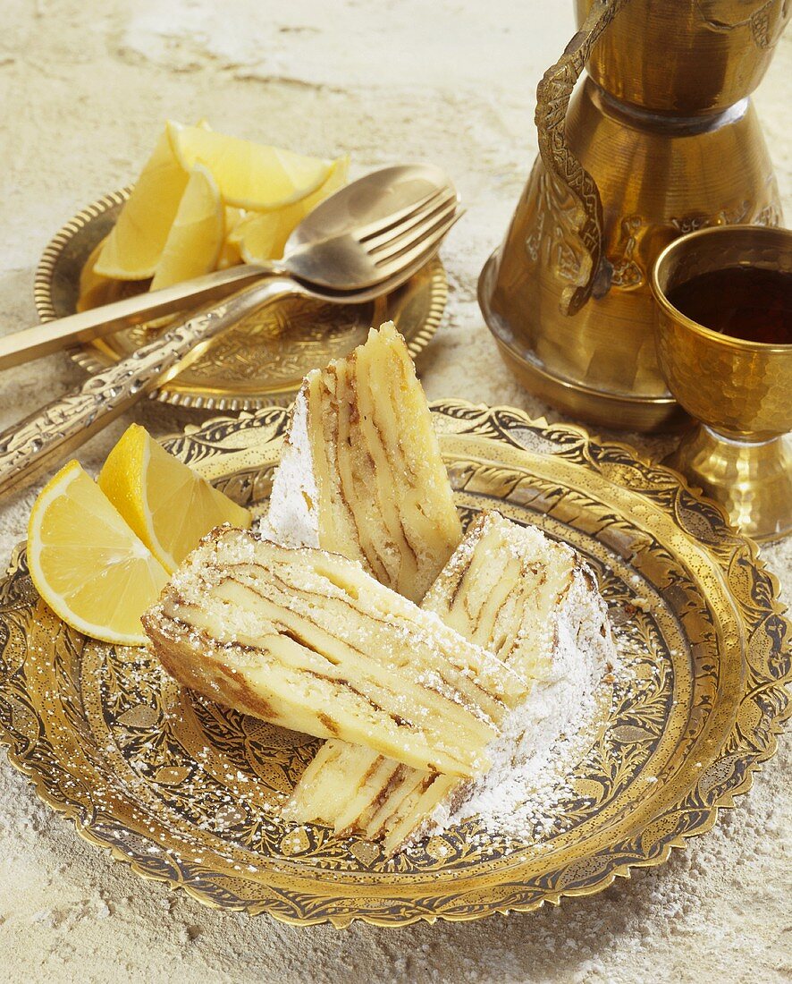 Three pieces of lemon cake with metal tableware