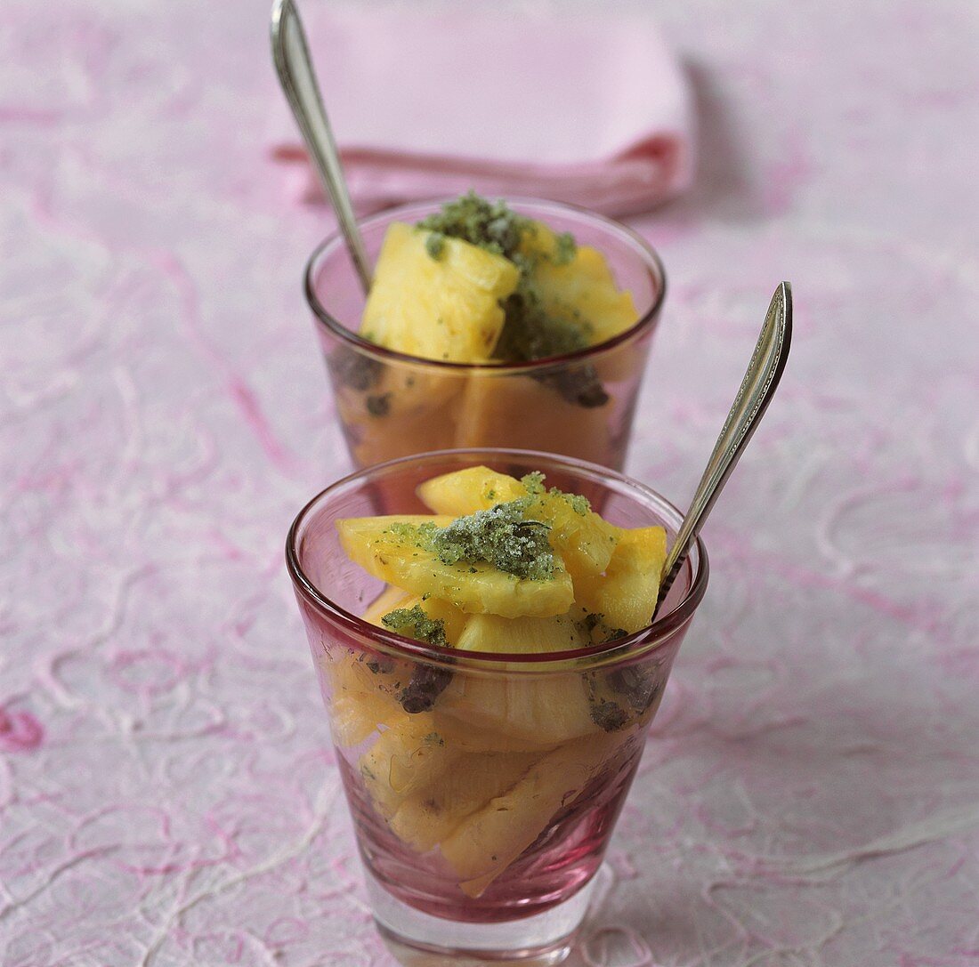 Pieces of pineapple with mint granita in two glasses