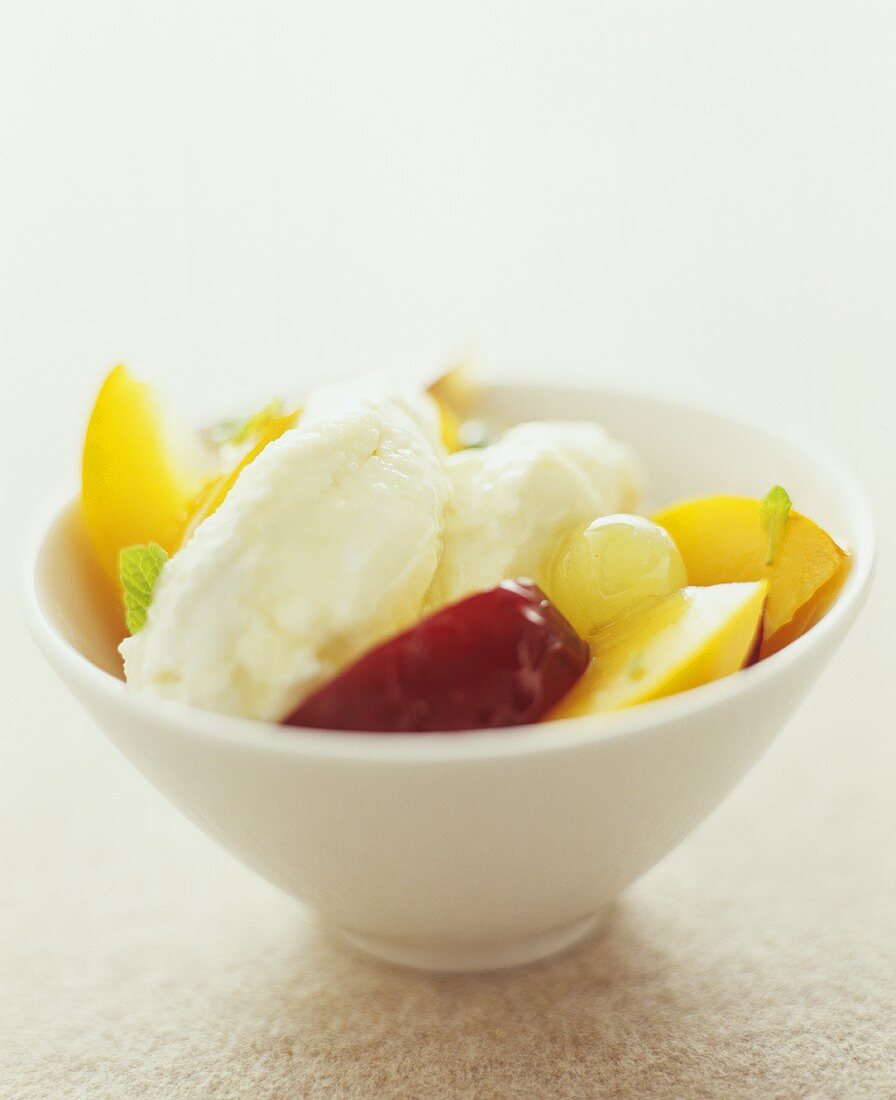 Ricotta dumplings with nectarines and grapes in a bowl
