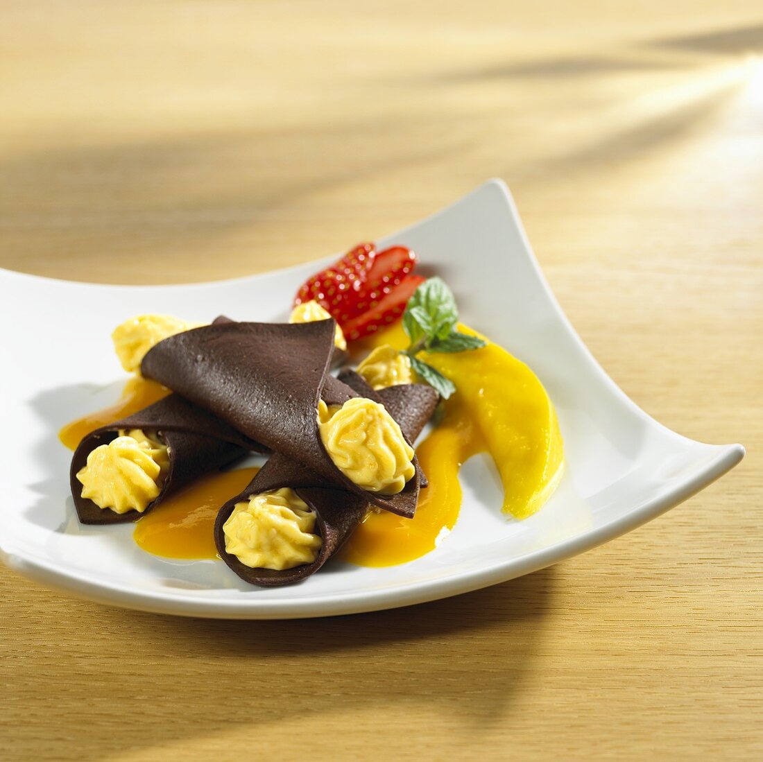 Chocolate cannelloni filled with mango cream