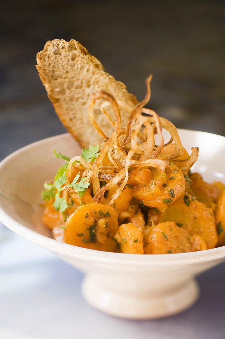 Warm carrot salad with fried onions and toast