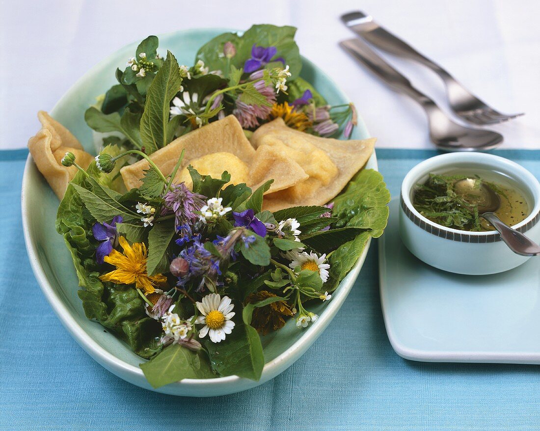 Wild herb salad with pasta squares filled with soft cheese