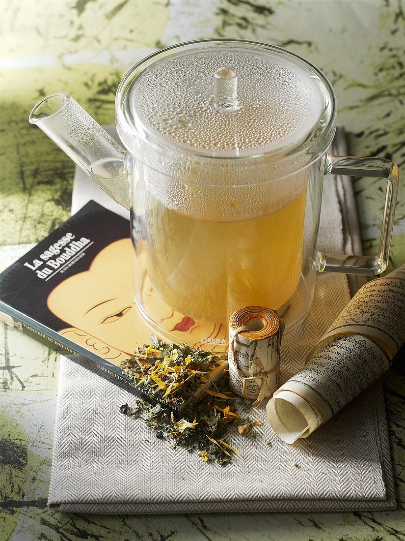 A pot of herbal tea on a book