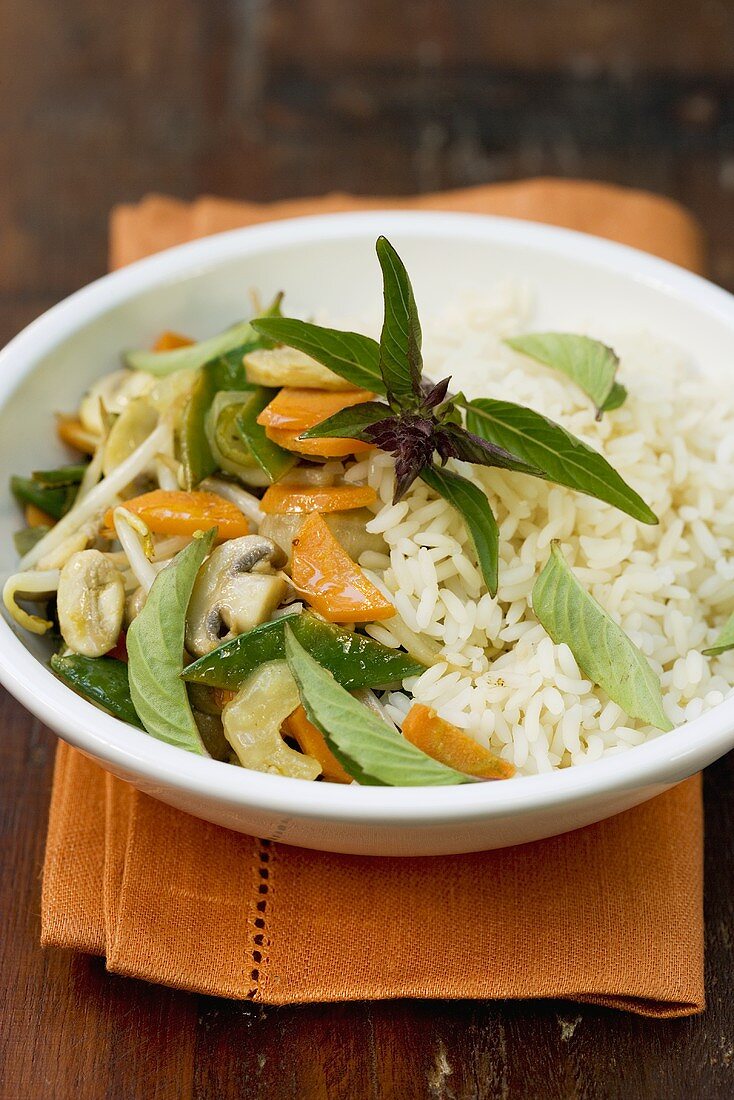 Stir-fried vegetables with Thai basil on rice