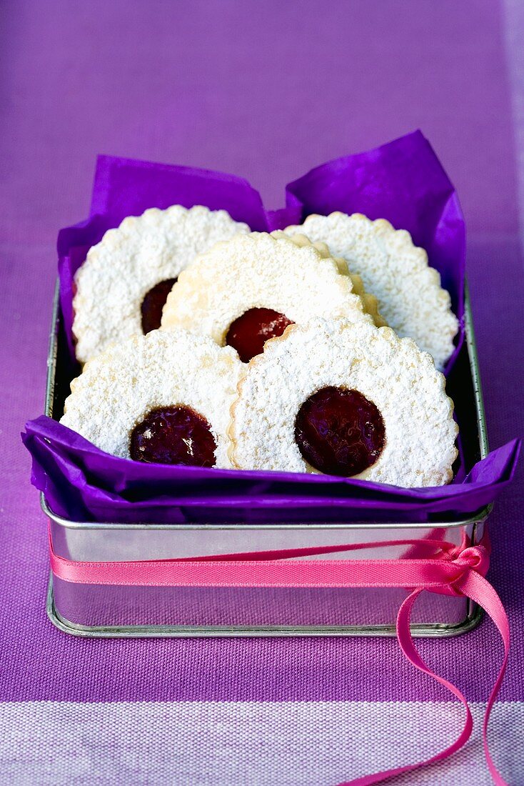 Linzer biscuits in a biscuit tin