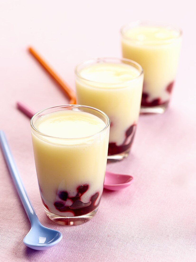 Vanilla cream with cherry sauce in three glasses