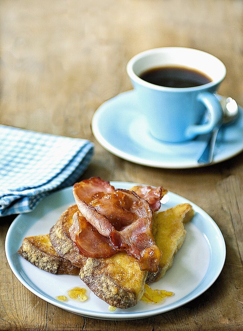 French toast with fried bacon and a cup of coffee