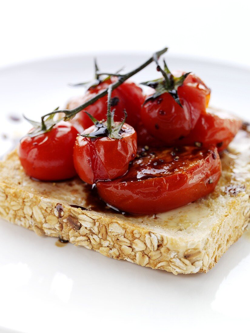 Cheese, tomatoes and balsamic vinegar on slice of toast