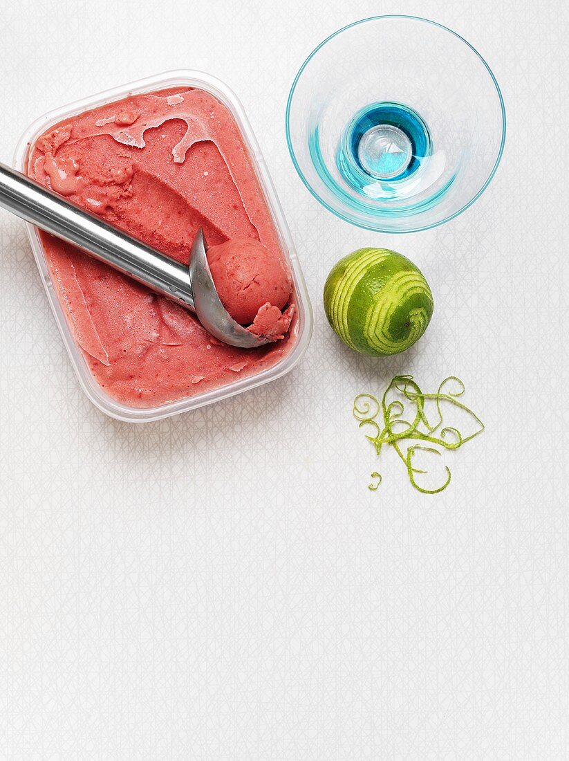 Raspberry & lime sorbet with ice cream scoop & sundae glass