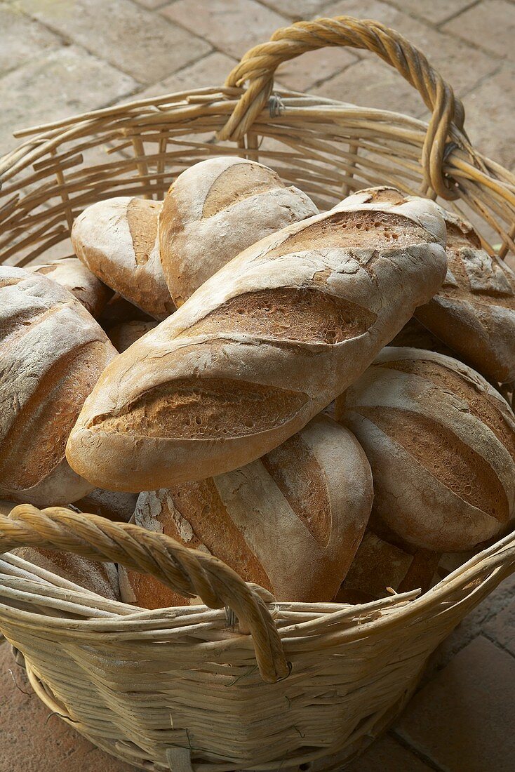 Home-made white loaves in a wicker basket