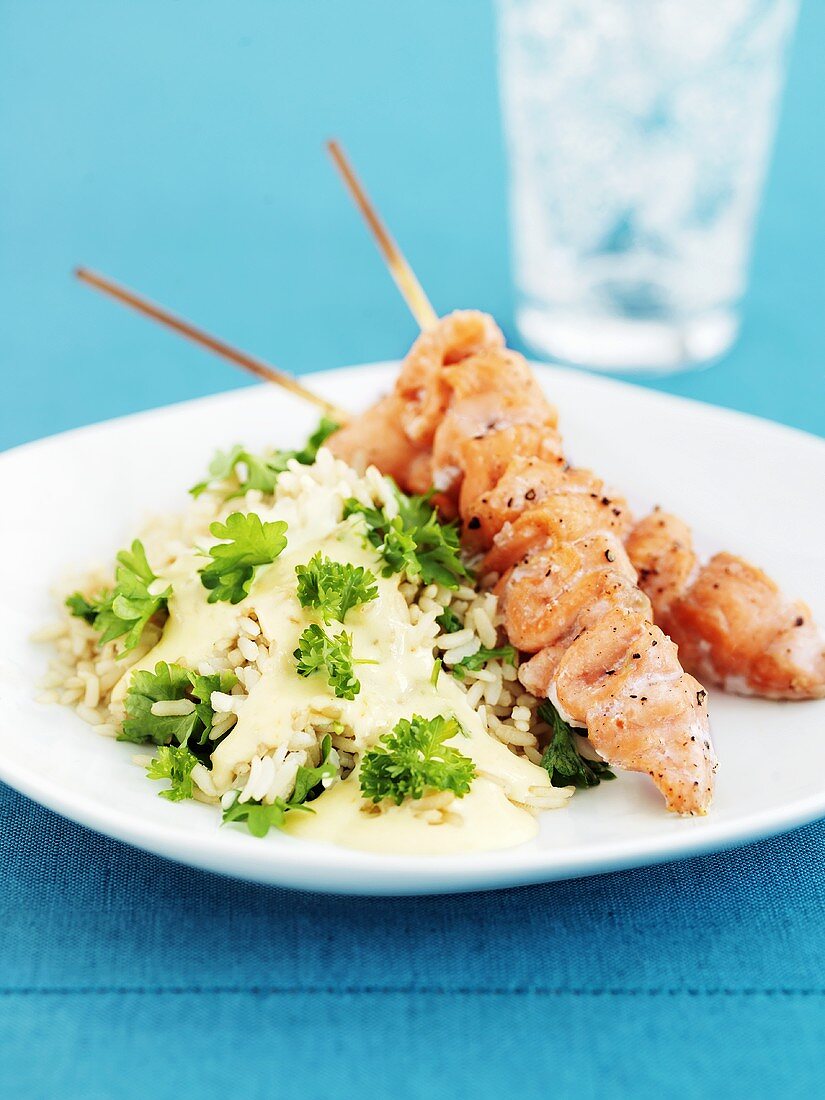 Grilled salmon kebabs with rice and parsley
