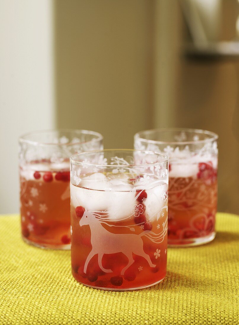 Three glasses of cranberry lemonade with ice cubes for kids