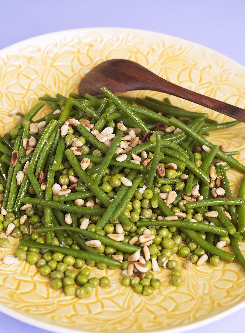 Peas and beans with pine nuts on a plate