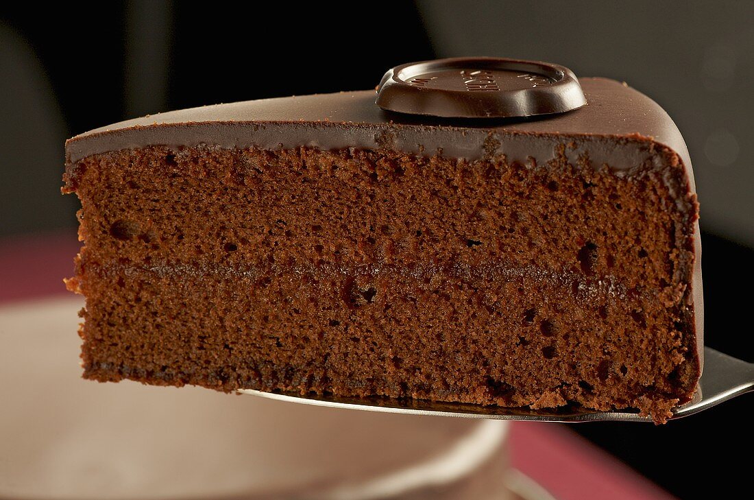 A piece of Sachertorte (chocolate cake) on a cake slice