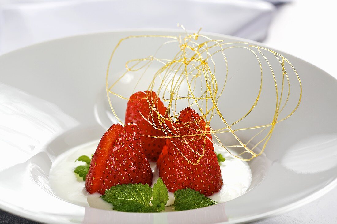 Buttermilk cream with strawberries, lemon balm and caramel