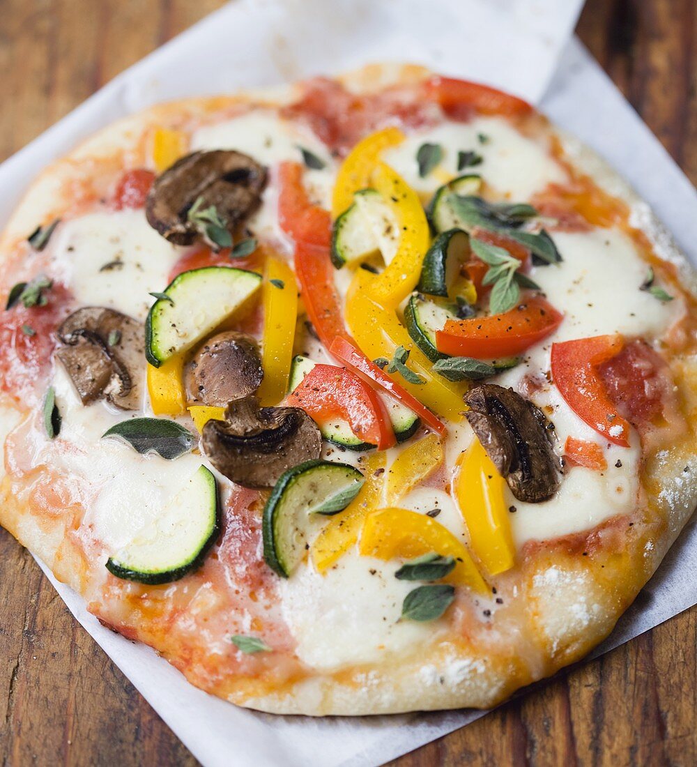 Vegetarian pizza topped with vegetables and mozzarella