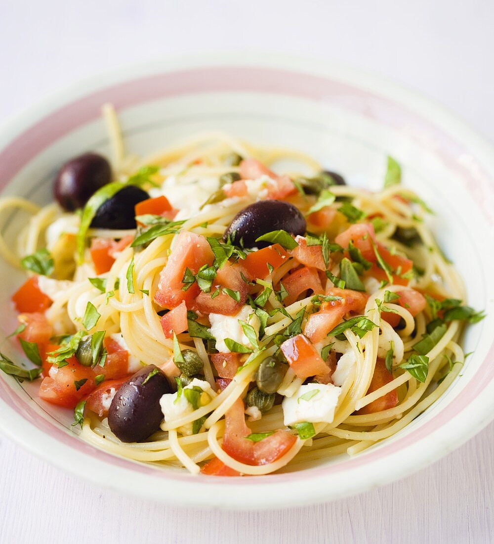 Spaghetti with olives, tomatoes, capers, mozzarella, basil