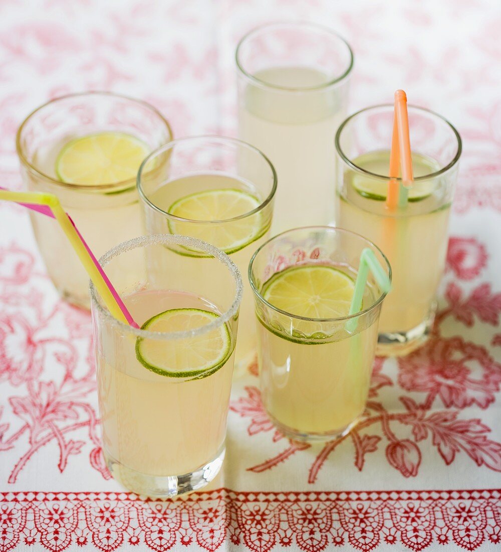 Six glasses of lemonade with straws