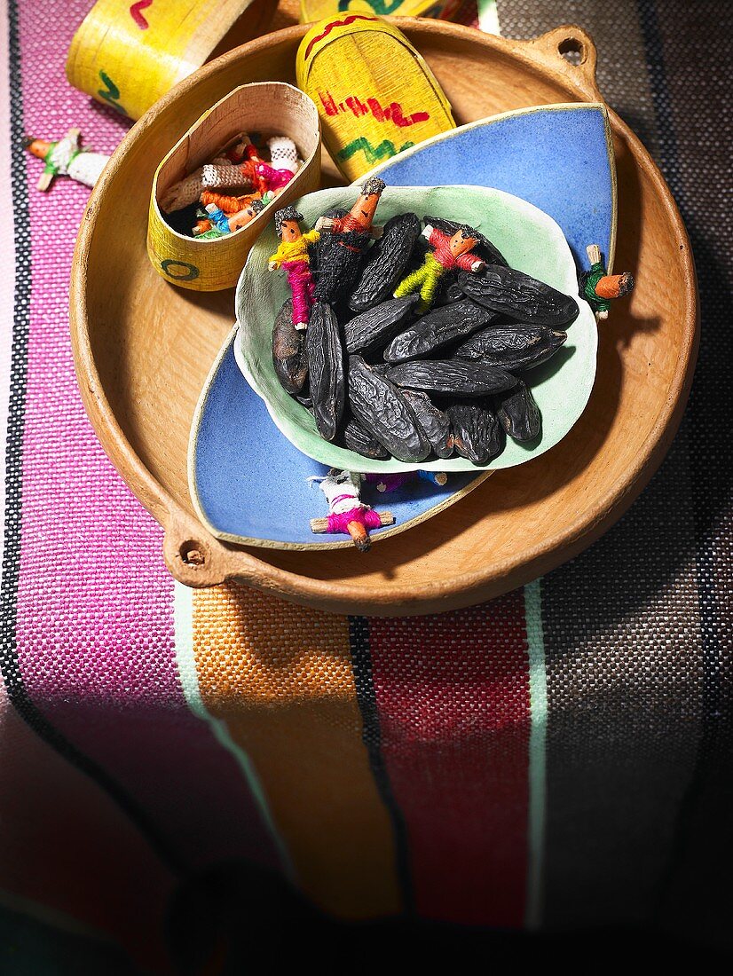 Tonka beans and toys in a wooden dish