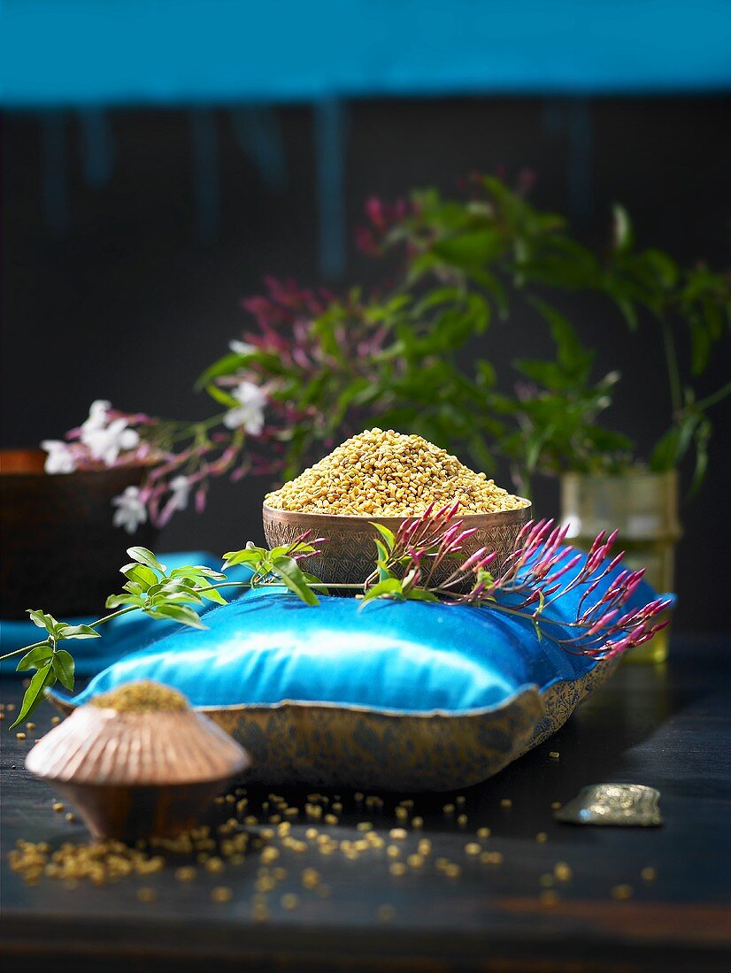 A small bowl of fenugreek seeds on a cushion