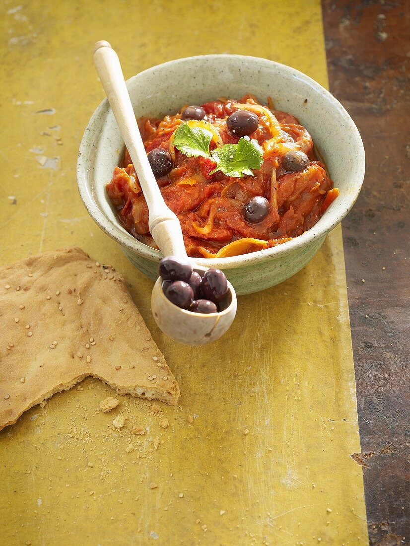 Peppers and onions with olives and flatbread