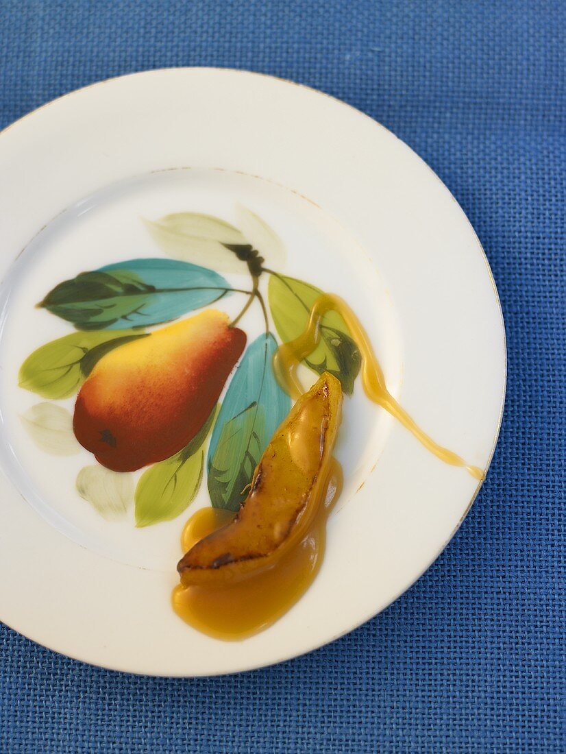 Caramelised slice of Williams pear on a plate