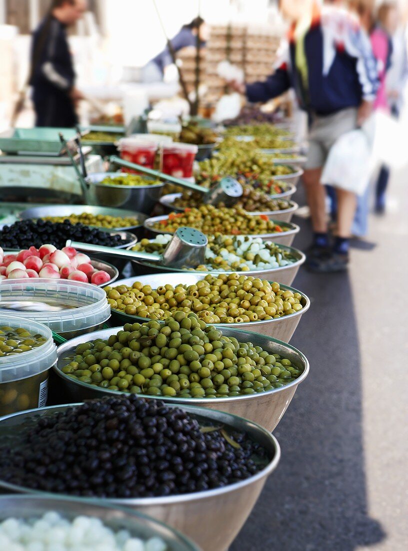 A selection of pickled olives on a market stall