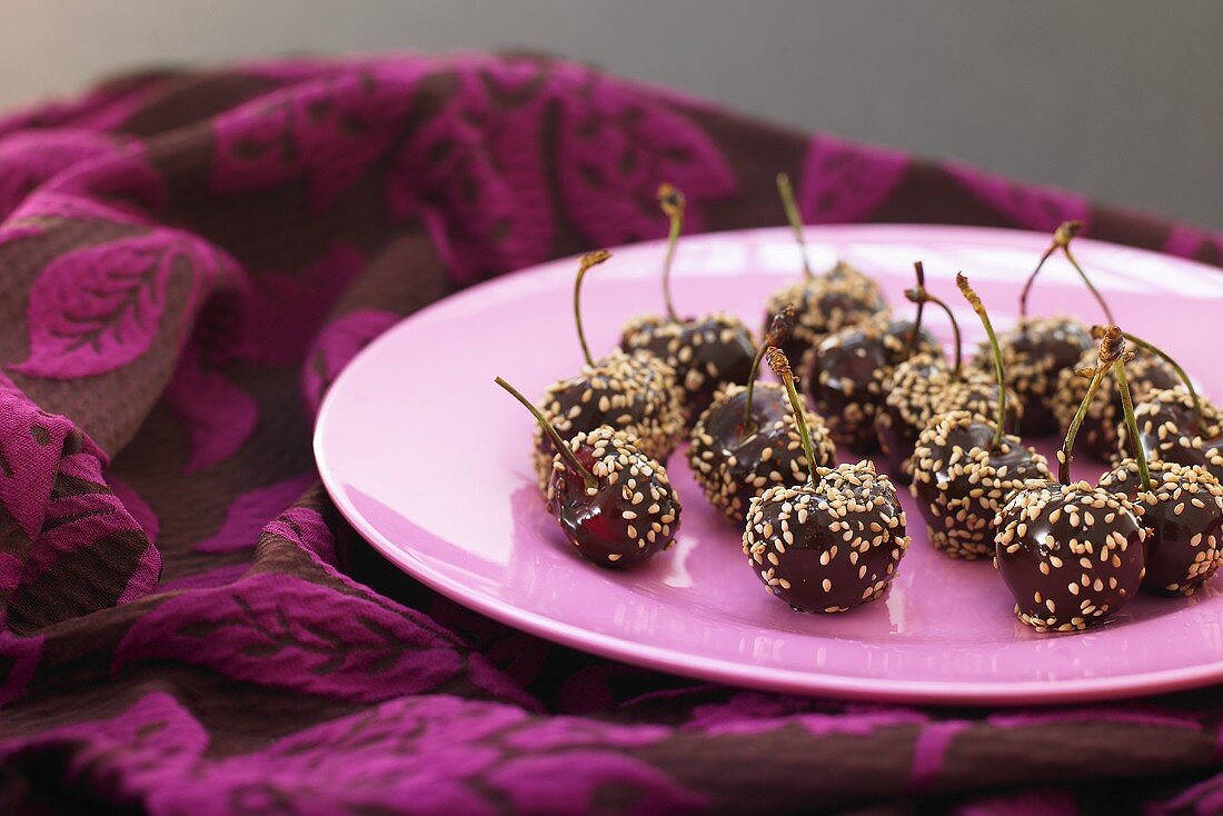 Chocolate-coated cherries with sesame seeds