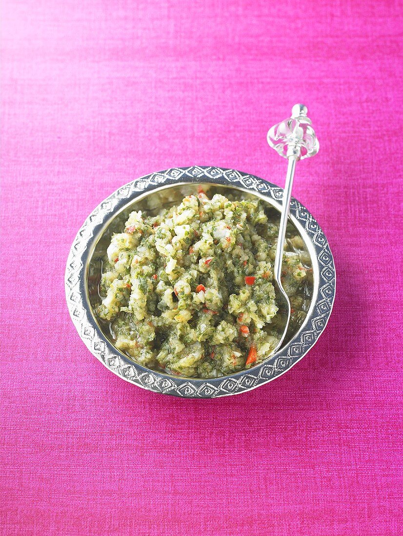 Minted onion chutney in a dish with a spoon