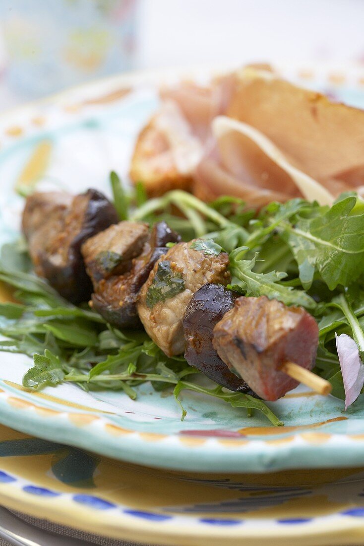 Appetisers: lamb and fig kebab, rocket salad and Parma ham