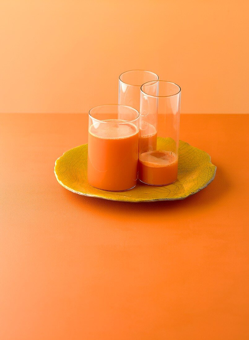 Three glasses of orange and carrot juice