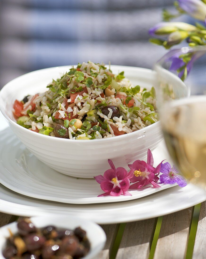 Rice salad with alfalfa sprouts, olives, chick-peas, tomatoes