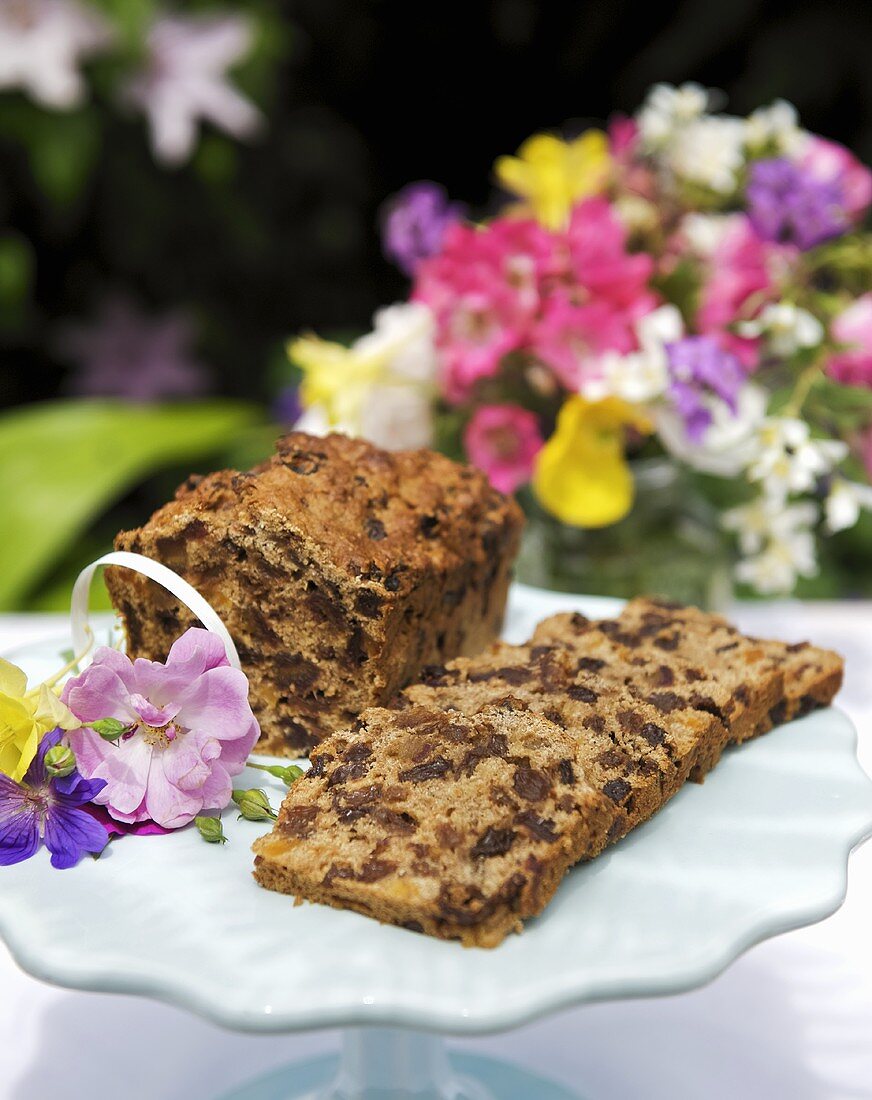 Fruit loaf on a cake stand decorated with flowers