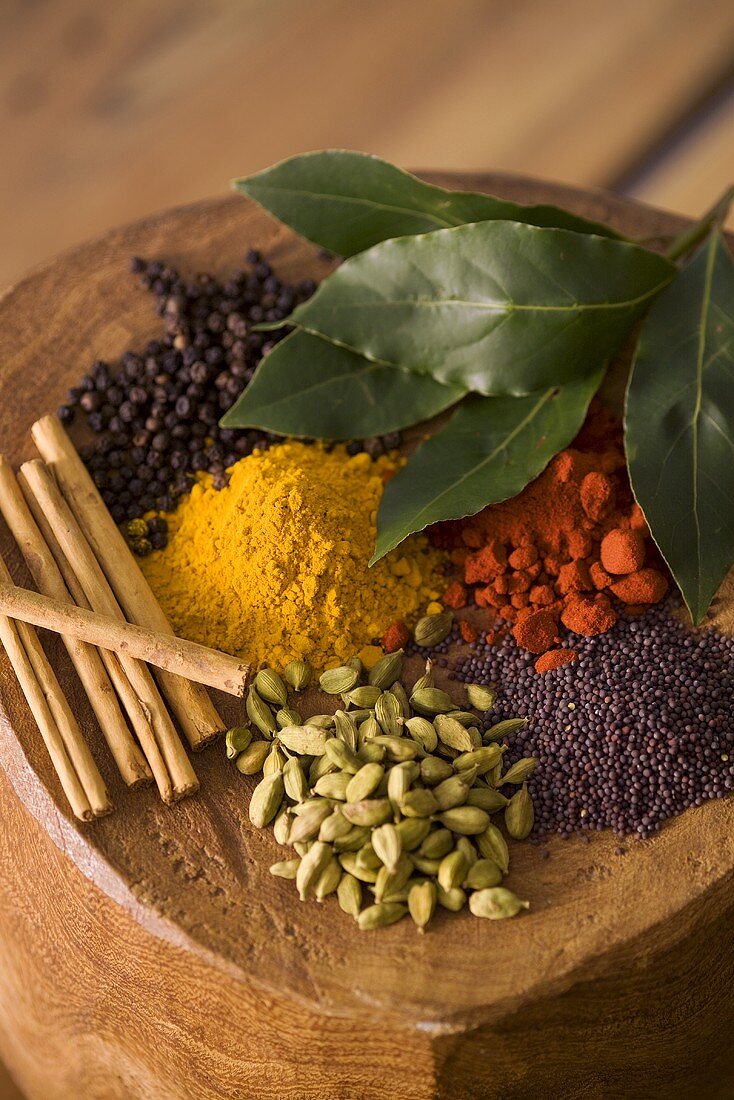 Assorted exotic spices on wooden background