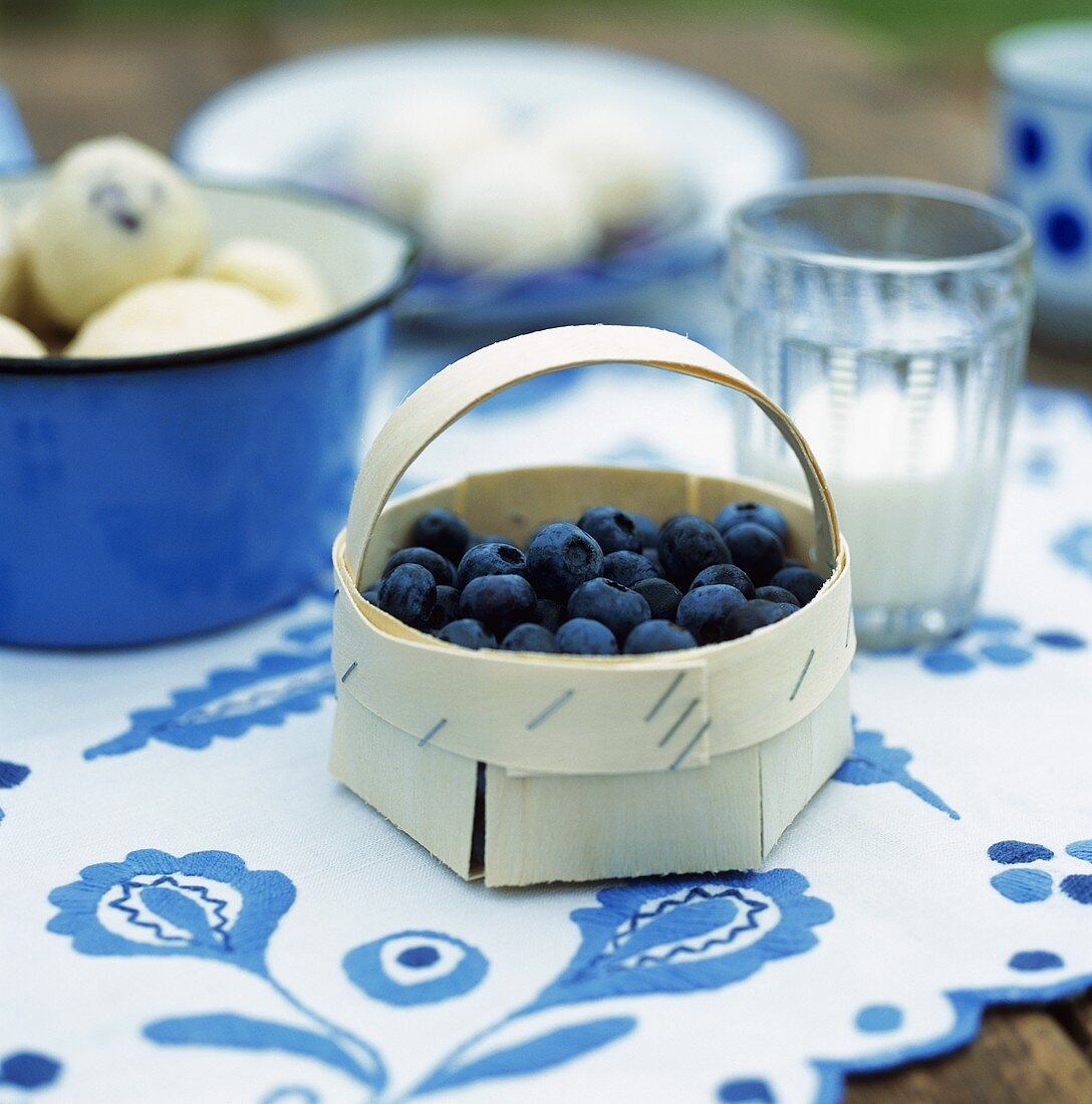 Fresh blueberries in a small woodchip basket
