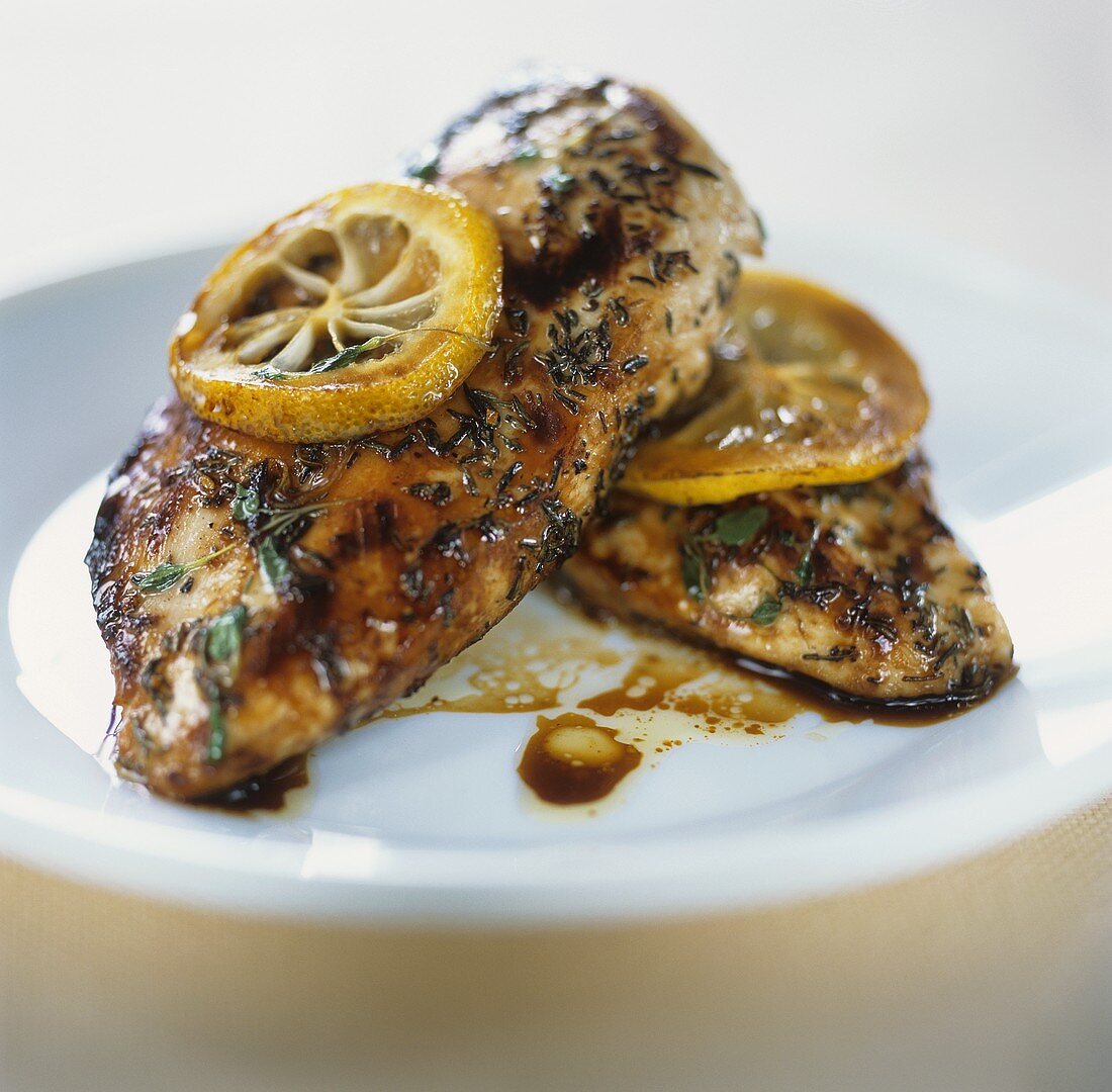 Two chicken breasts with herbs and lemon