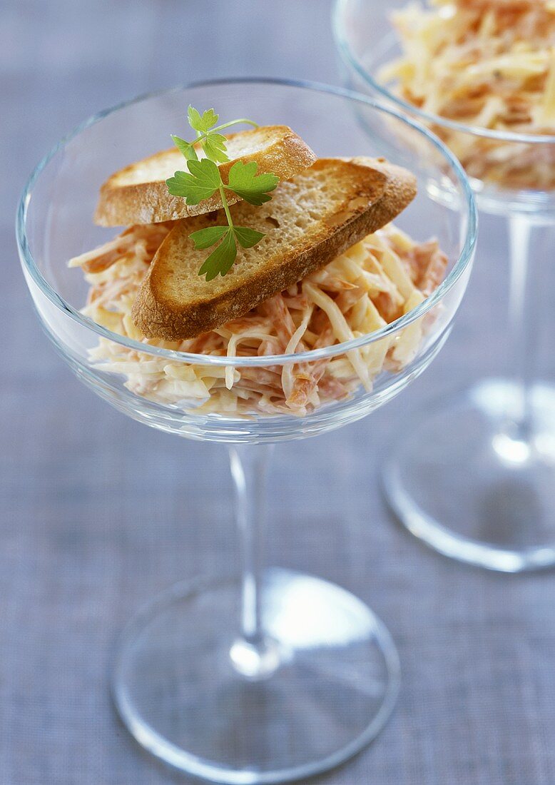 Carrot & cheese salad with toasted white bread in two glasses