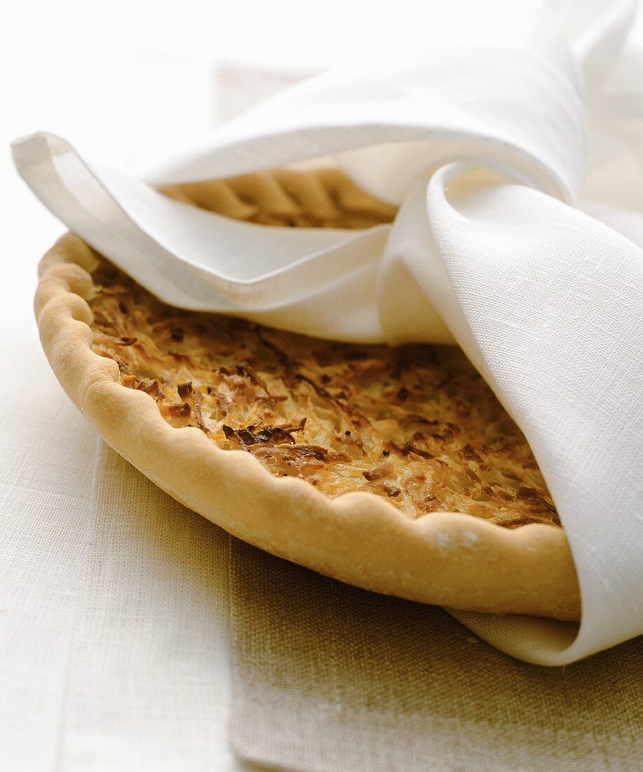 An onion tart wrapped in a fabric napkin