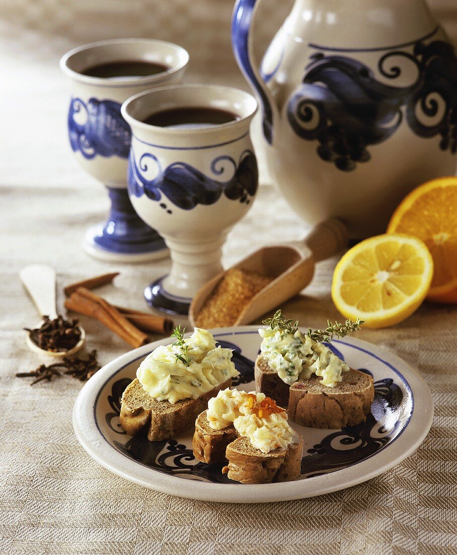 Mulled wine in jug & cups with wholemeal bread & herb butter