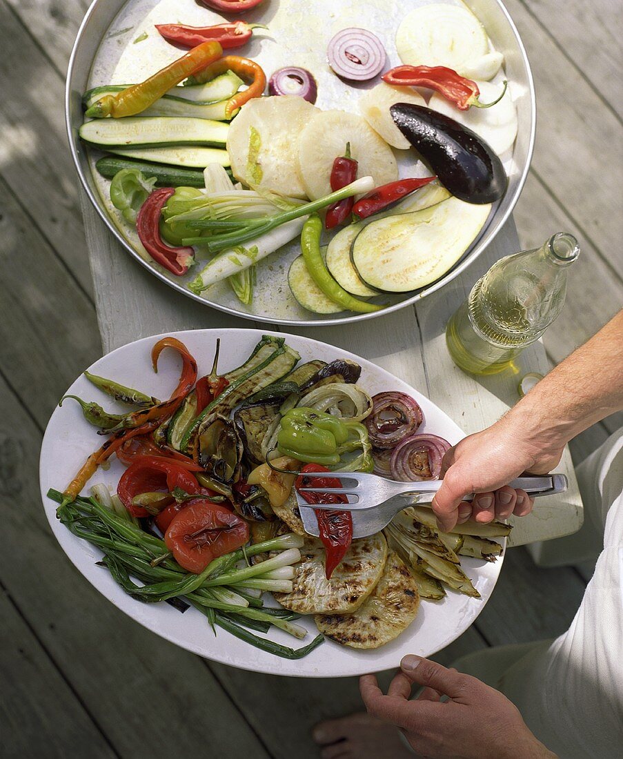 Barbecued and raw vegetables on platters