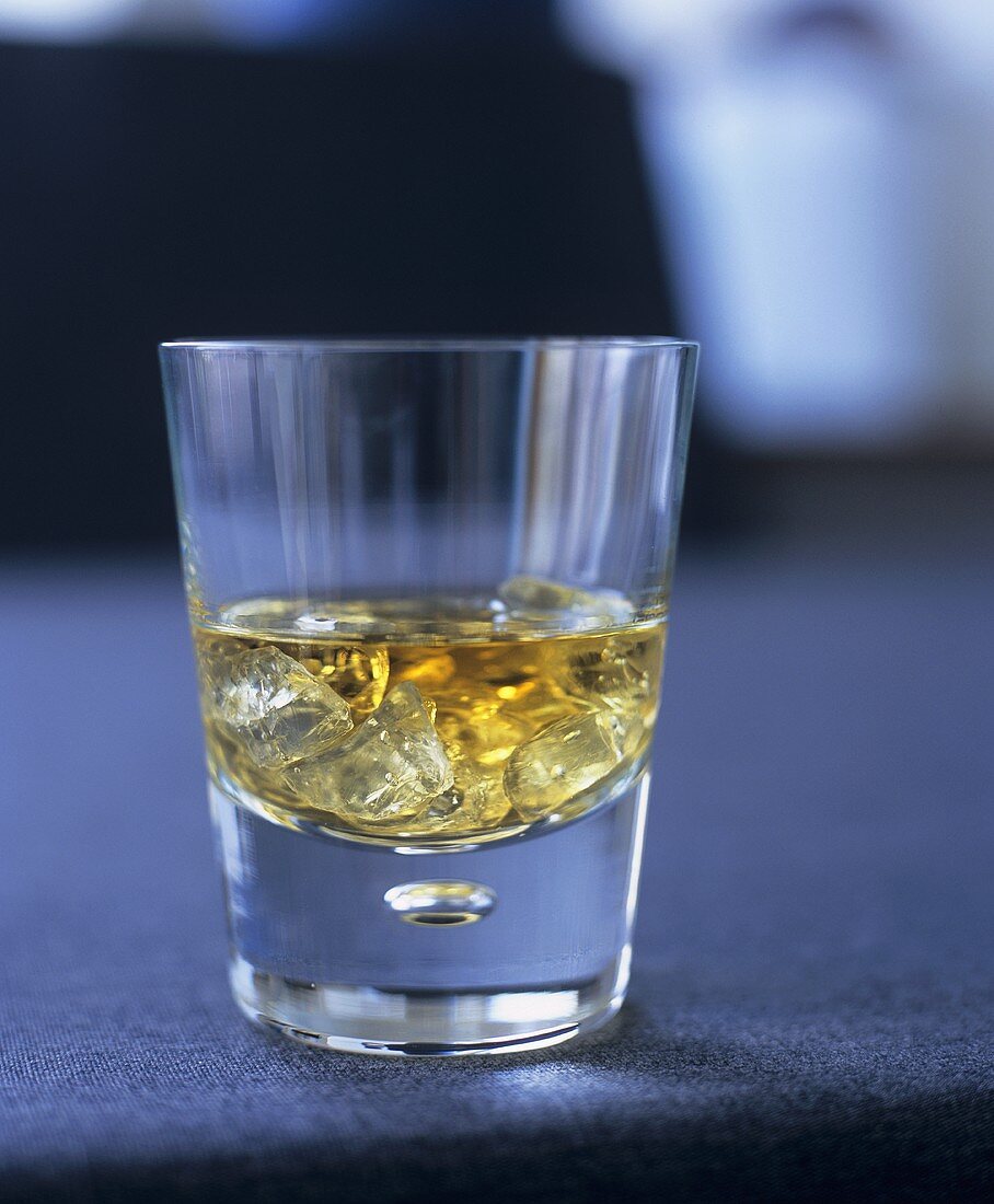 A glass of whisky with ice
