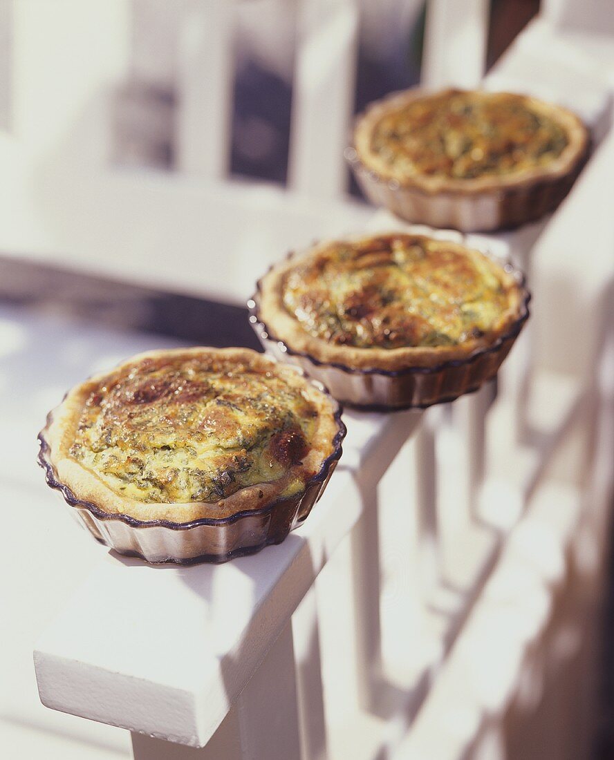 Three individual nettle quiches