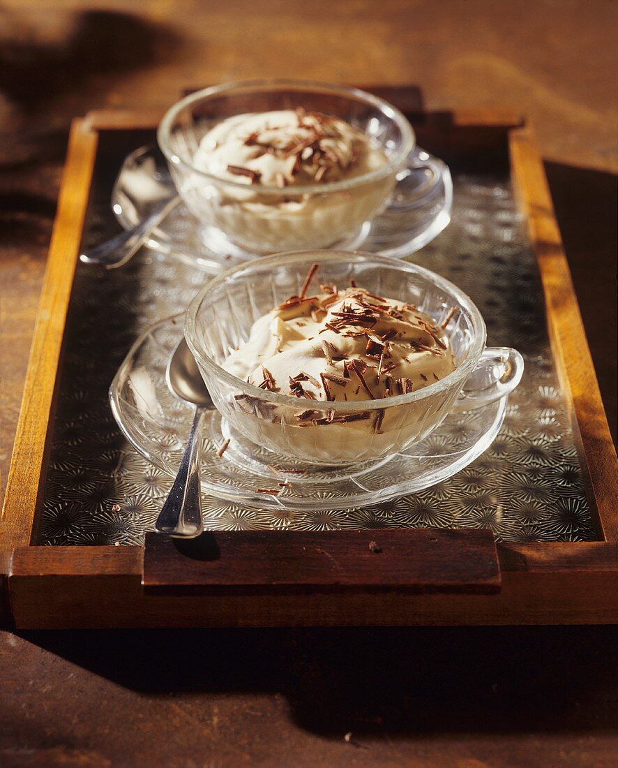 Coffee quark cream with chocolate in two cups and saucers