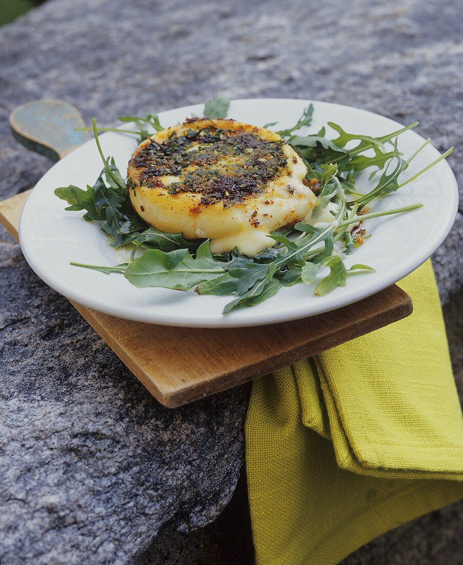 Fried Robiola cheese in herb crust on rocket