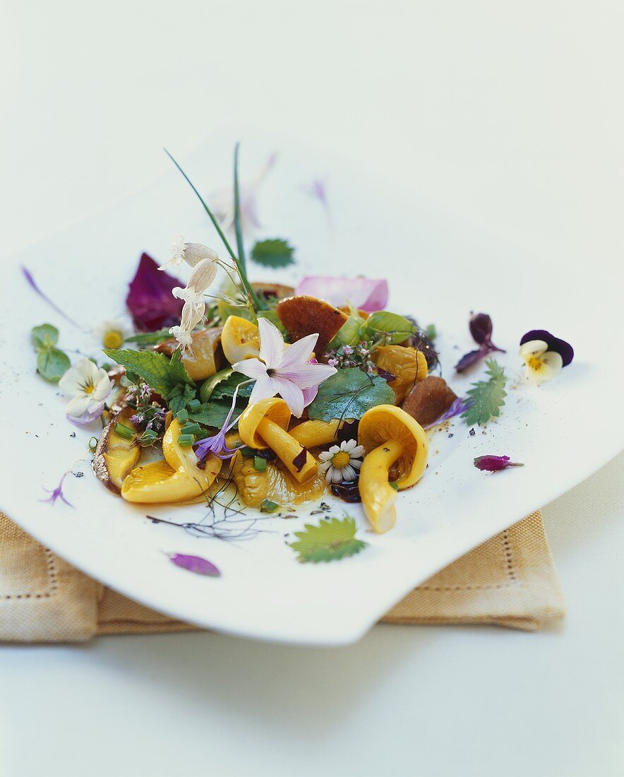 Wild herb salad with edible flowers and mushrooms