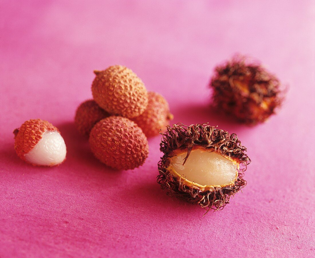 Unpeeled and partially peeled lychees and rambutan